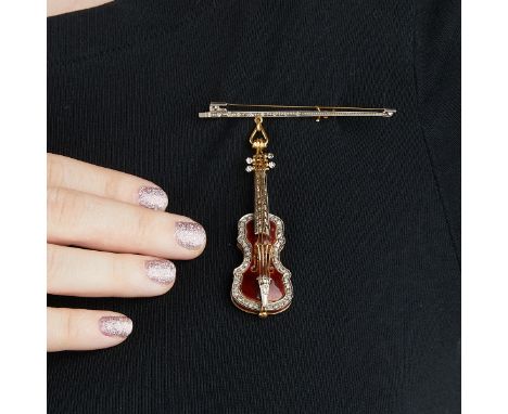 Stradivarius 18k yellow gold, diamond, and enamel brooch. The bow is inset with seven diamonds and with a pin along the back.