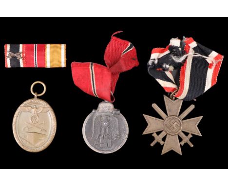 Three German Third Reich medals comprising War Service Cross second class with swords, Russian Front medal and West Wall Camp