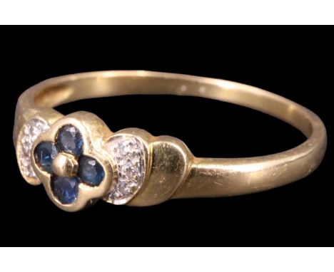 A contemporary sapphire and diamond finger ring, having four 1.5 mm sapphire brilliants set in a quatrefoil bezel centred by 