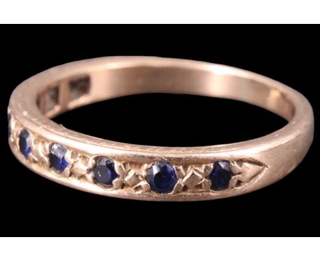 A sapphire half-hoop eternity ring, set with nine 1.5 mm sapphire brilliants in a 9 ct yellow metal shank marked '9ct', mid 2