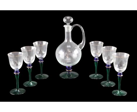 A free-blown green, blue and gilt glass decanter jug, decorated with wheel-cut swags and having a ground-in stopper, together
