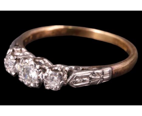 A George V three stone diamond ring, having a central 3 mm brilliant diamond between two 2 mm brilliants, illusion set in pre