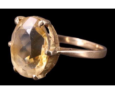 A Victorian citrine finger ring, having an oval stone of approximately 3.25 carats set on a hand-pierced gallery between open