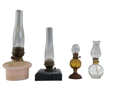 Three oil lamps having glass reservoirs, together with one other lamp, tallest 42 cm