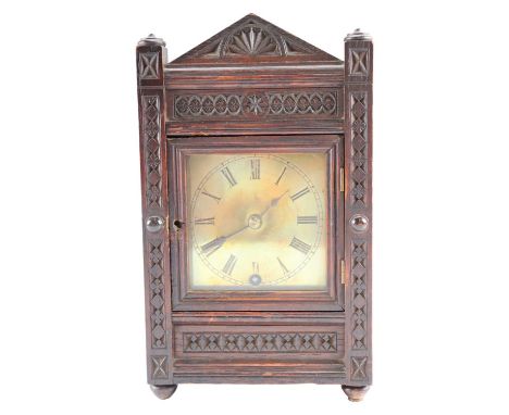 A late 19th-century chip-carved carved oak mantle or shelf clock, 28 cm x 17 cm x 12 cm (runs briefly)