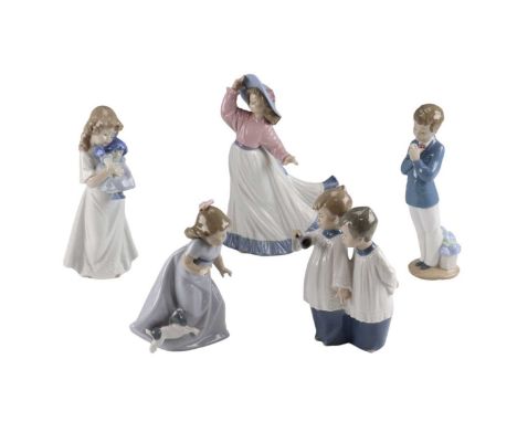 Five Nao figurines including choir boys and a young girl and dog, tallest 24 cm