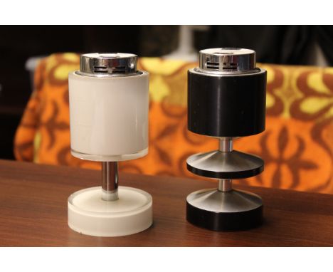 Two stylish cylindrical vintage Japanese table lighters, one white and one black 