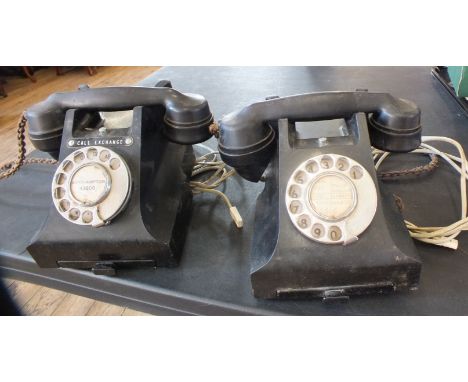 Two vintage bakelite telephones with braided cords and modern adapters