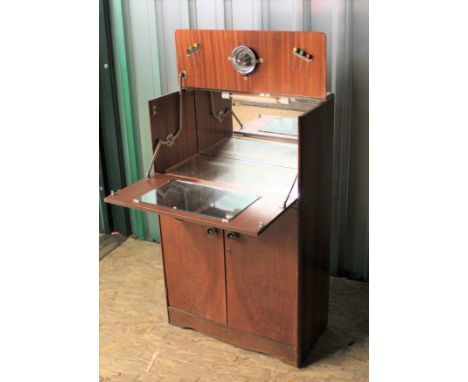 A vintage upright cocktail cabinet with some accessories