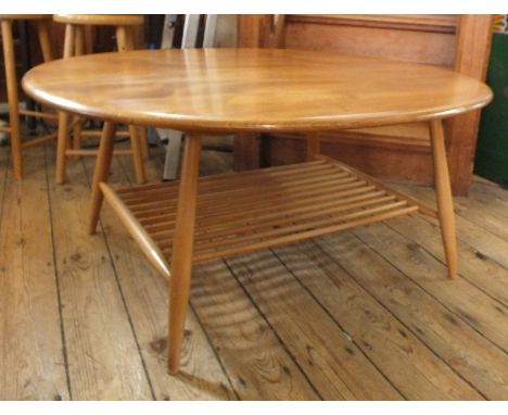 An Ercol light elm oval two-tier coffee table approx 33" x 39"