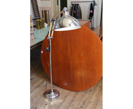 An adjustable chrome and wood standard lamp with chromed, bell shaped shade.  This item is sold as a Collectors item only and