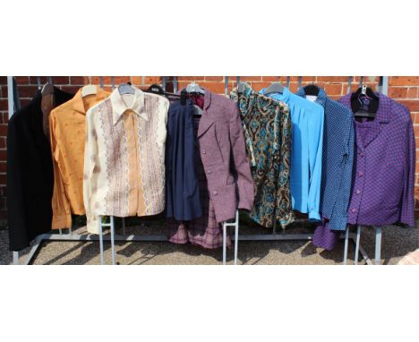 A collection of vintage lady's clothing including blouses, two piece skirt suit, a skirt and a jacket