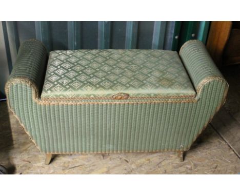 An unusual vintage green loom linen box with rounded ends and padded seat to centre on legs