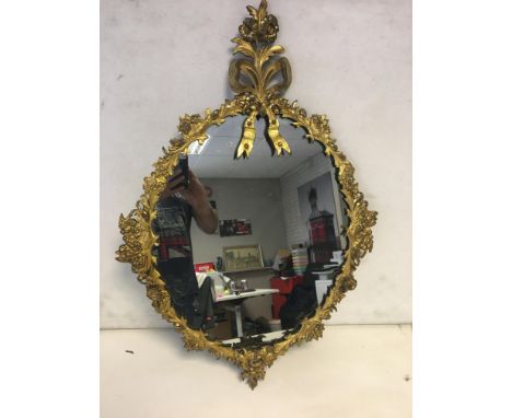 Gilt floral metal framed mirror.