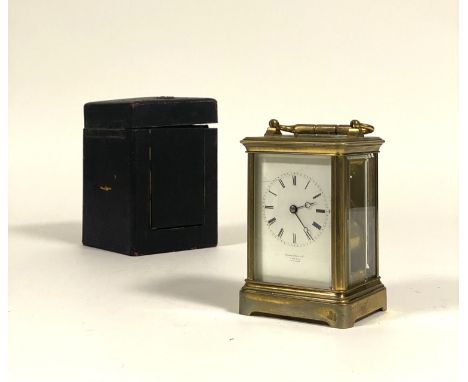 A French brass repeating carriage clock, late 19th century, the gilt brass case with swing handle and bevelled glass panels e