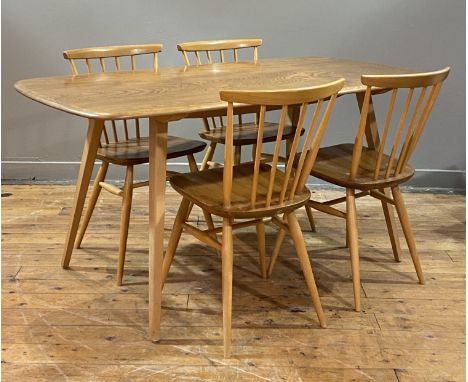 Ercol, A vintage dining suite, circa 1970's / 80's, comprising a dining table with shaped elm top raised on tapered and splay