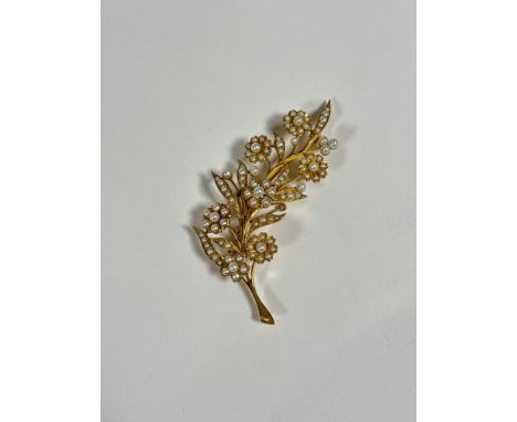 A large seed pearl brooch, late 19th century, modelled as a floral spray, the flowerheads and leaves each set with seed pearl