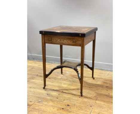 An Edwardian rosewood envelope top card table, with four boxwood strung and marquetry panels opening to reveal a baize-lined 