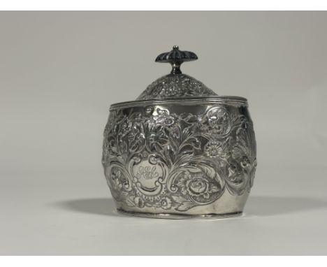 A George III Provincial silver tea caddy, William Welch II, Exeter 1808, of oval bombe form, the hinged cover with ebony knop