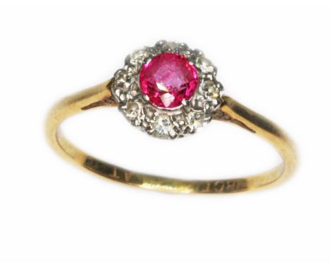 A diamond and ruby cluster ring, the cluster measuring approx. 8mm in diameter, band marked '18ct PLAT', gross wt. 2g, size O