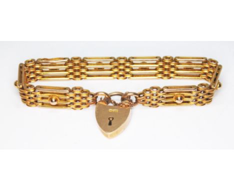 An early 20th century gate bracelet, heart shape padlock clasp and two end links marked '9c', length 16cm, wt. 21.8g.  Condit
