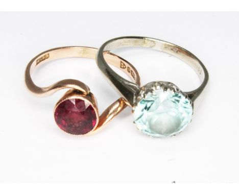 Two rings; a hallmarked 9ct gold garnet ring and a white metal ring set with a blue zircon marked '9ct', gross wt. 5g, size N