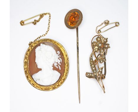 A mixed lot of jewellery comprising a shell cameo brooch marked '9', a yellow metal stick pin and a split pearl floral brooch