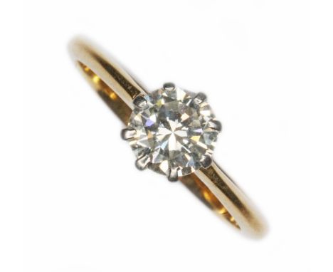 A mid 20th century diamond solitaire ring, the eight claw set round cut stone weighing approx. 0.61cts, band marked '18ct' &a