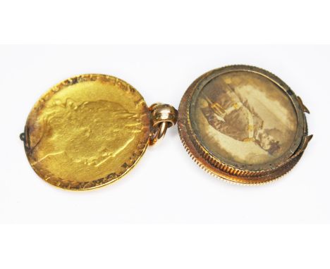 A bloodstone locket pendant fob, formed from a George III 1791 guinea, hinged and opening to reveal a portrait, the reverse s