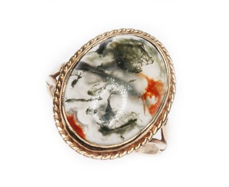 A moss agate cabochon ring, rope twist and bezel mounted agate measuring approx. 16mm x 13mm, hallmarked 9ct gold, sponsor in