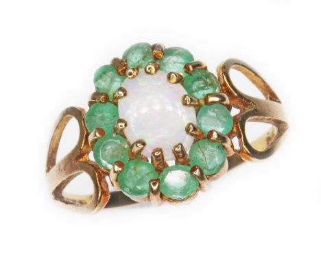 An opal and emerald cluster ring, the oval cluster measuring approx. 13mm x 11mm, hallmarked 9ct gold, sponsor 'MK', London, 