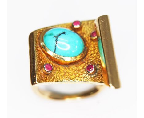 A modernist turquoise and ruby ring, textured and shaped scroll set with a central turquoise cabochon and four bezel set roun