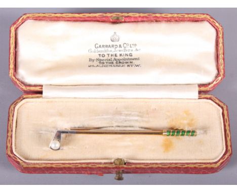 A gold, enamel and pearl bar brooch, in the form of a golf club and ball, in fitted Garrard & Co box