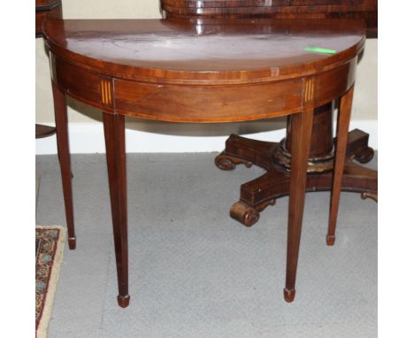 A late Georgian mahogany and banded semicircular fold over top card table, on square taper supports