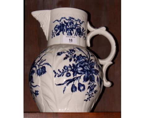 An 18th Century Worcester china jug, body moulded leaves with blue floral decoration, crack to handle, 12" high
