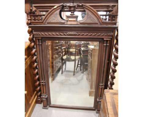 A 19th Century bevelled plate wall mirror, in carved arch top frame with central vase finial and fluted pilasters, 55" x 36"