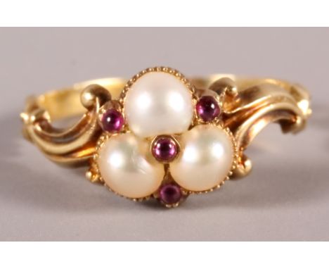 A 19th Century gold mourning ring set pearls and rubies, size L