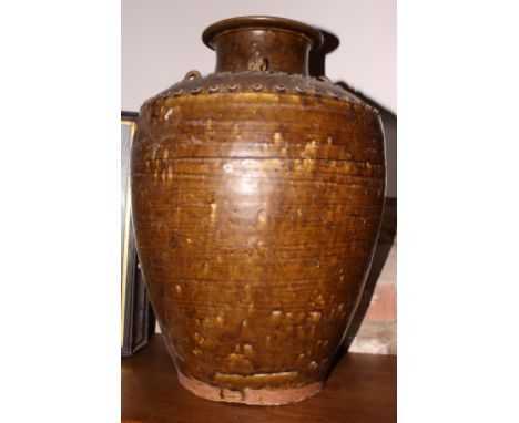 A Chinese stoneware brown glazed storage jar with ring handles, 19 1/2" high (surface damages)