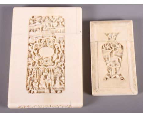 A Chinese carved ivory card case with landscape panel and four flower carved panel verso, 4 1/2" long, and a smaller similar 