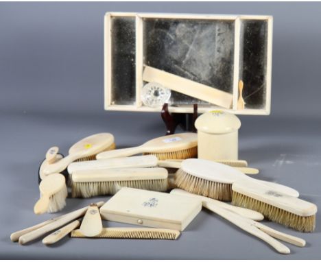 A late 19th Century ivory dressing table set comprising mirror-based tray, trinket box, brushes, ivory backed mirror, glove s