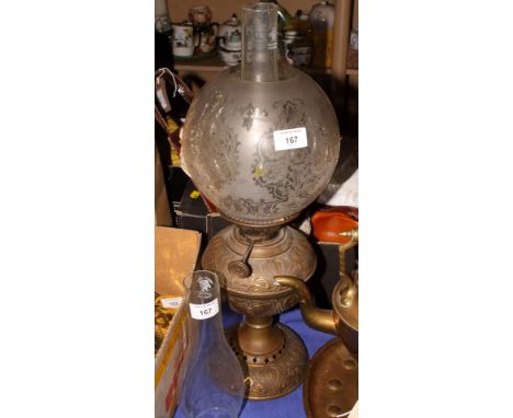 A brass pedestal oil lamp with etched glass shade and two chimneys