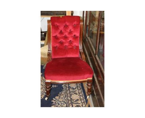 A Victorian mahogany framed nursing chair with buttoned back and overstuffed seat, upholstered in a red velour, and a Lusty L