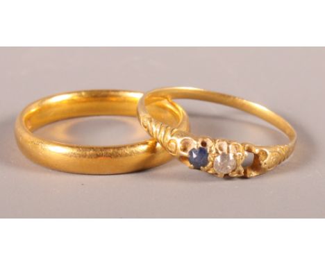 A 22ct gold wedding band, 4.5g, and a yellow gold three-stone dressing ring (one stone missing), 1.5g