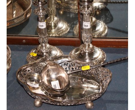 A Georgian silver and whalebone handled punch ladle, a pair of silver plated candlesticks, on weighted bases, a plated cake b