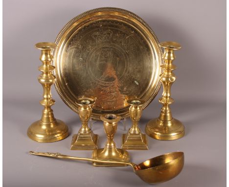 A Victorian jubilee brass tray, a brass ladle, two plated brass candlesticks and one other candlestick