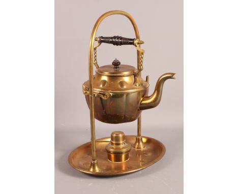 An early 20th Century brass spirit kettle, on stand with arch handle