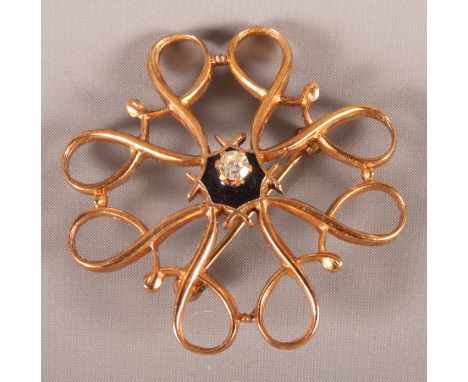 A 9ct gold diamond and black enamel brooch