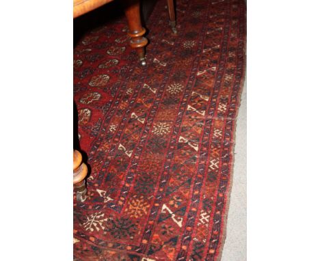 A Bokhara carpet decorated fifty hexagonal guls on a red ground with numerous narrow border stripes, 105" x 94" approx