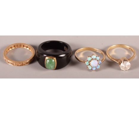 A 9ct gold and opal posy ring, a 9ct gold single stone dress ring, a jadeite mounted ring and a gold and diamond eternity rin