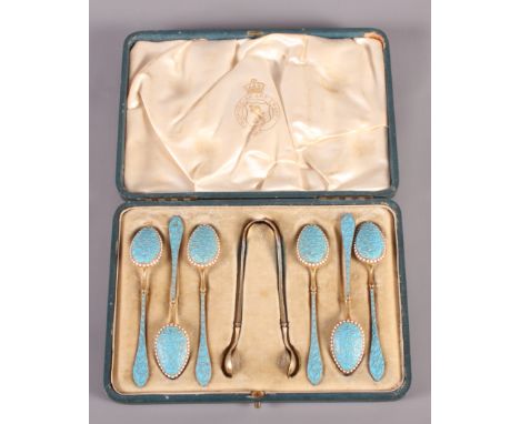 A set of six continental silver and enamel demi-tasse coffee spoons and matching tongs, in fitted case